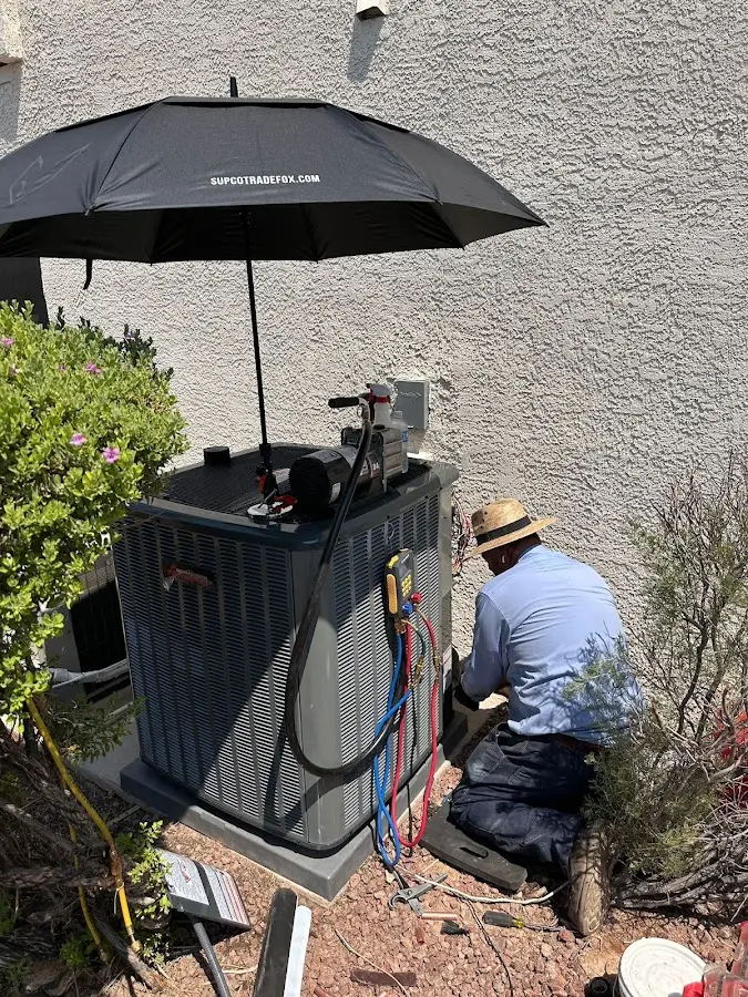 HVAC technician performing outdoor AC maintenance in La CaÃ±ada Flintridge