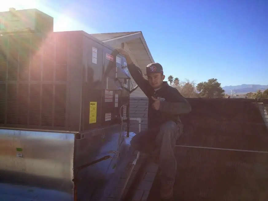 HVAC technician performing HVAC Inspection on a rooftop unit in La CaÃ±ada Flintridge